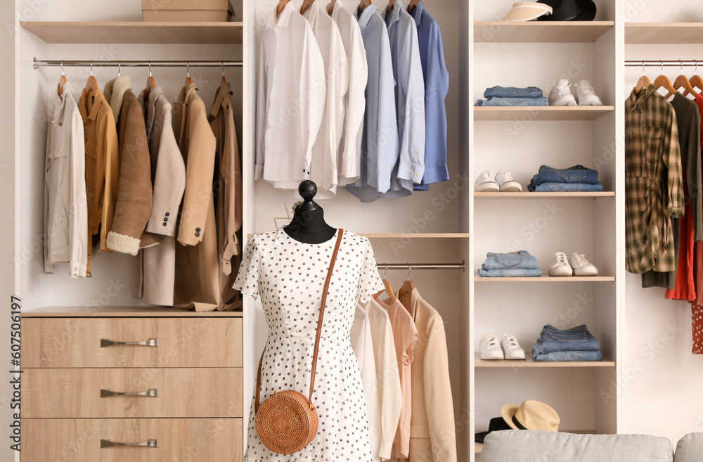 Interior of boutique with stylish clothes and mannequin