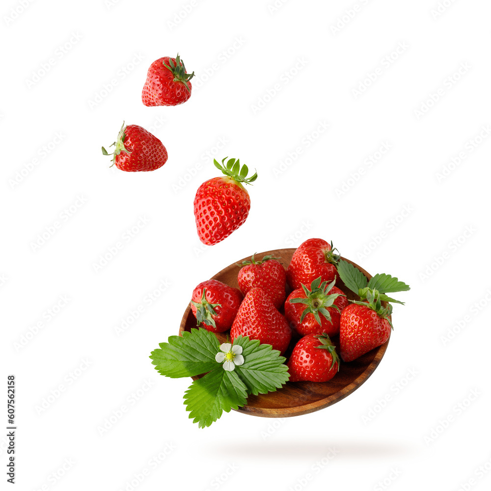 Fresh sweet strawberry and leaves  falling  flying on wooden plate isolated on a white background.