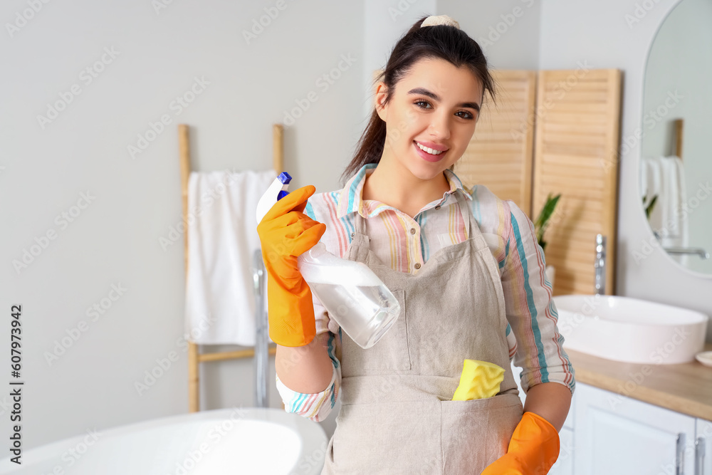 Young woman cleaning bathroom in her house