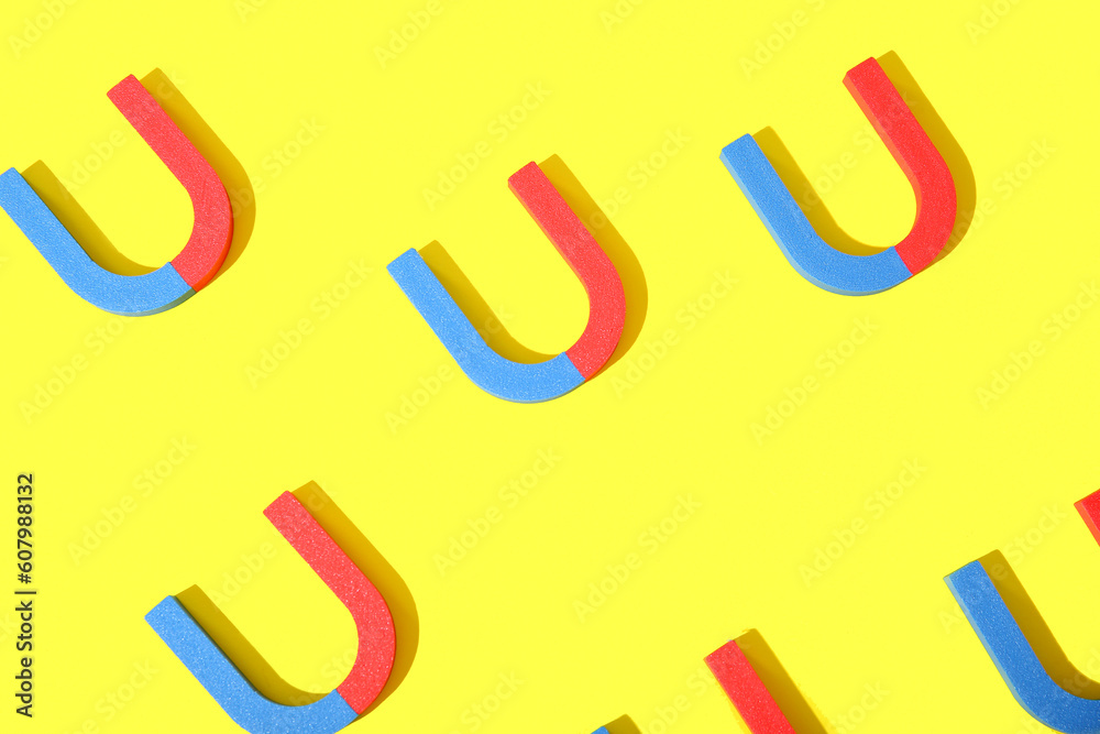 Horseshoe shaped magnets on yellow background