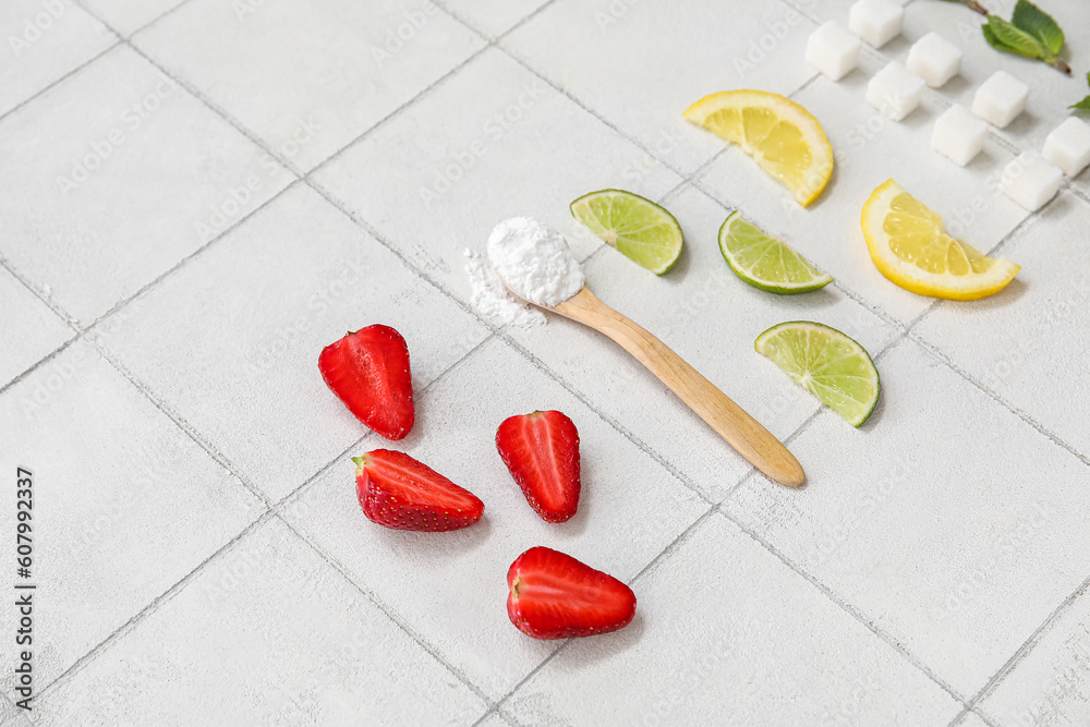 Ingredients for preparing strawberry compote on white tile background