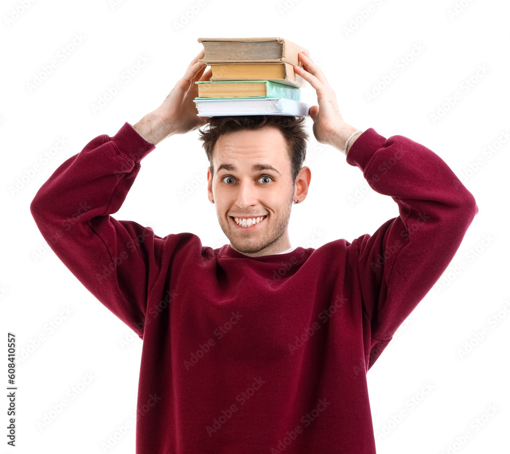 Young man with stack of books on white background