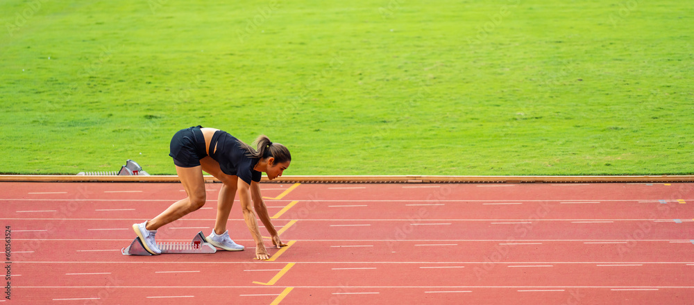 Asian young sportswoman sprint on a running track outdoors on stadium