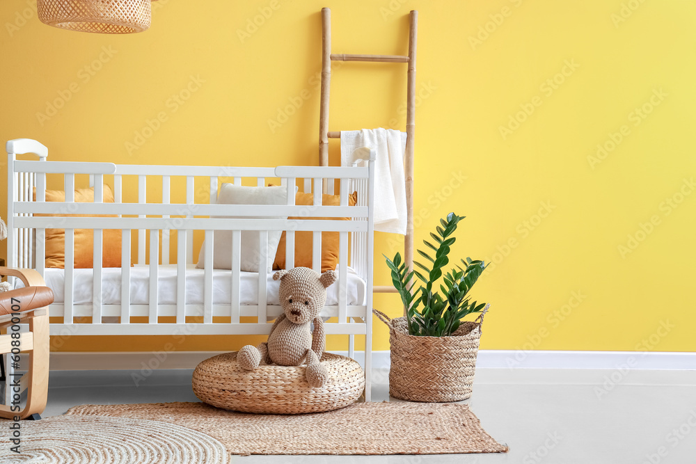 Interior of stylish bedroom with baby crib and ladder