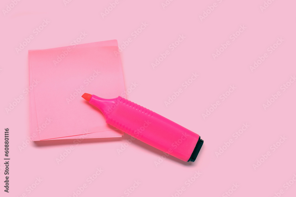 Sticky note with marker on pink background