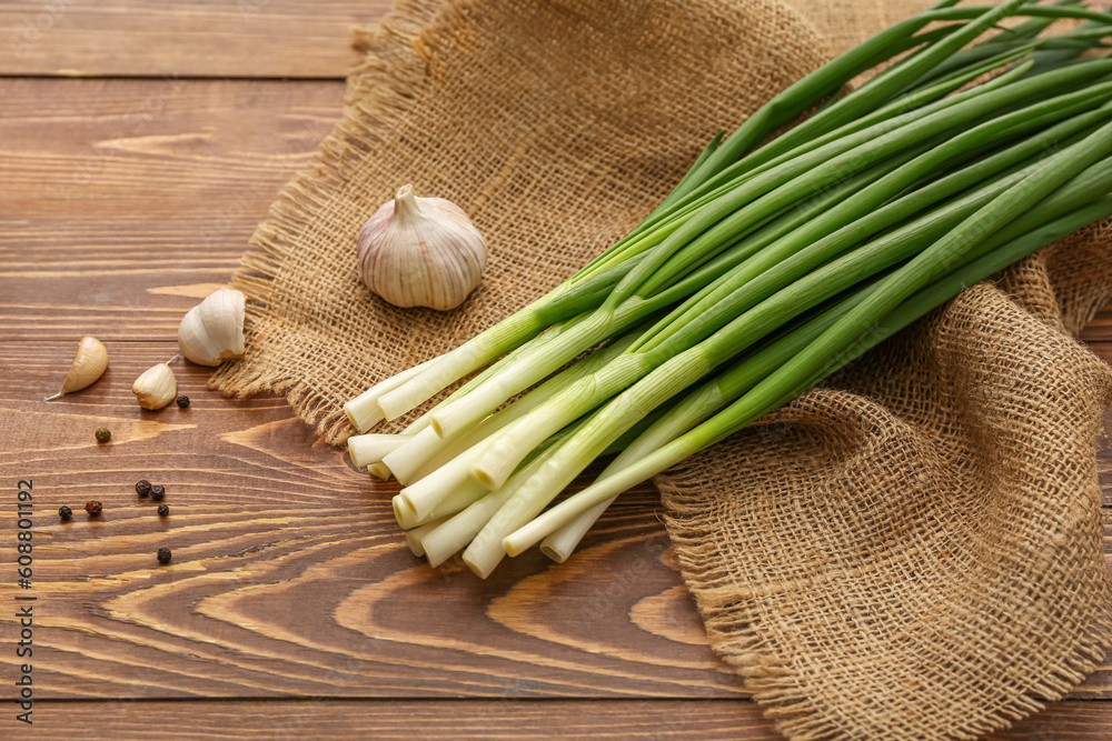 Fresh green onion on wooden background