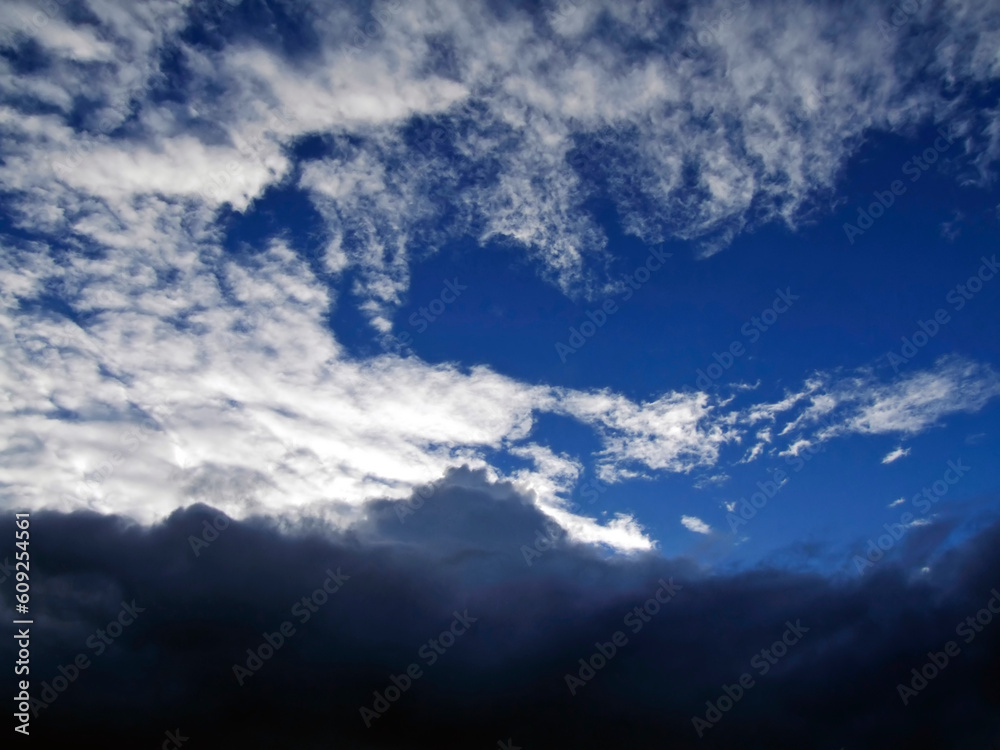 Storm clouds below blue skies captured during approach of stormfront over the Mediterranean Sea