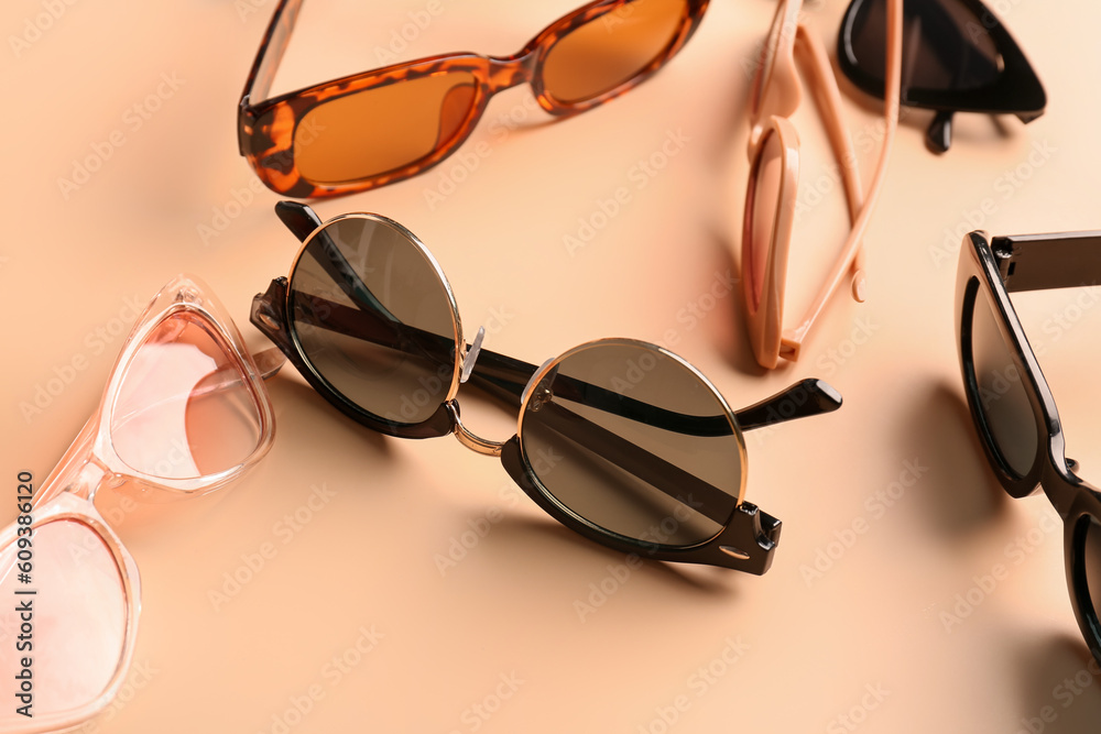 Stylish sunglasses on beige background