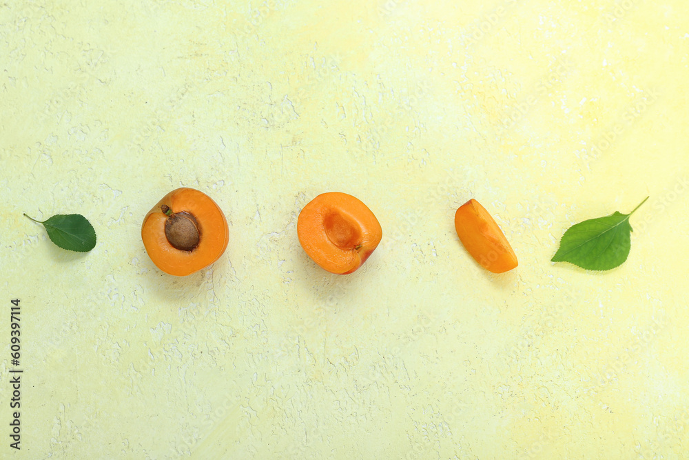 Fresh apricots on yellow background