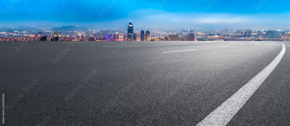 Asphalt pavement and urban building skyline