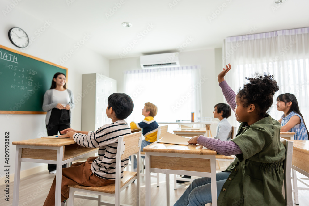 Group of student learn with teacher in classroom at elementary school. 