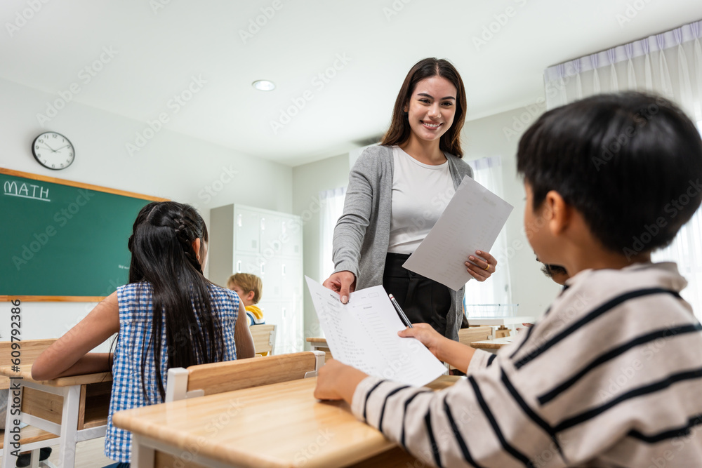 Group of student learn with teacher in classroom at elementary school. 