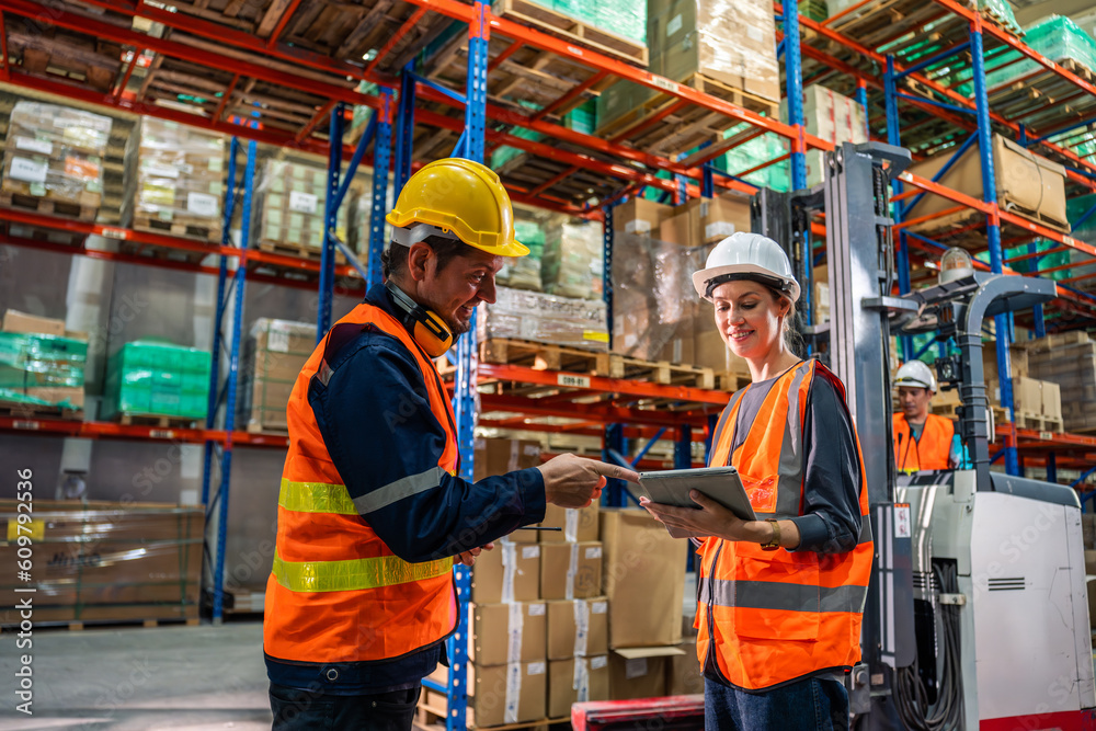 Caucasian man and woman industrial worker work in manufacturing plant. 