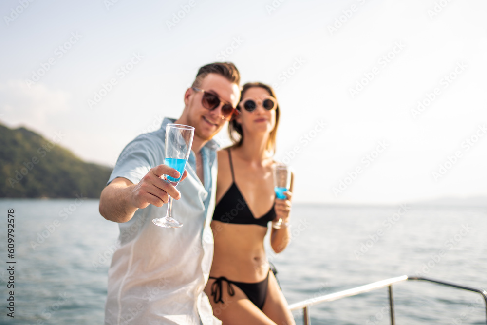 Portrait of Caucasian couple drinking champagne, having party in yacht.