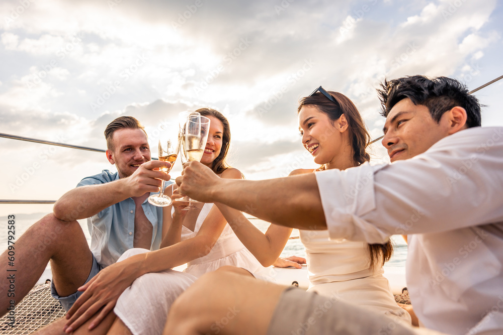 Group of diverse friends drink champagne while having a party in yacht. 