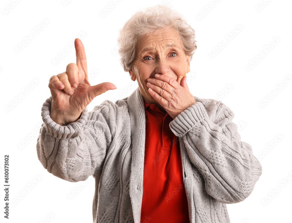 Senior woman showing loser gesture on white background