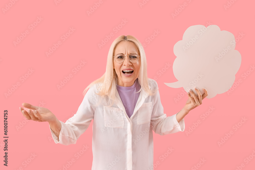 Angry mature woman with blank speech bubble on pink background