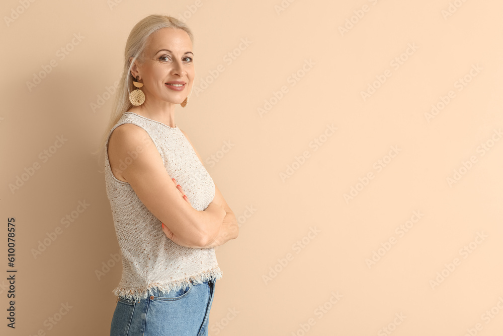 Mature blonde woman on beige background