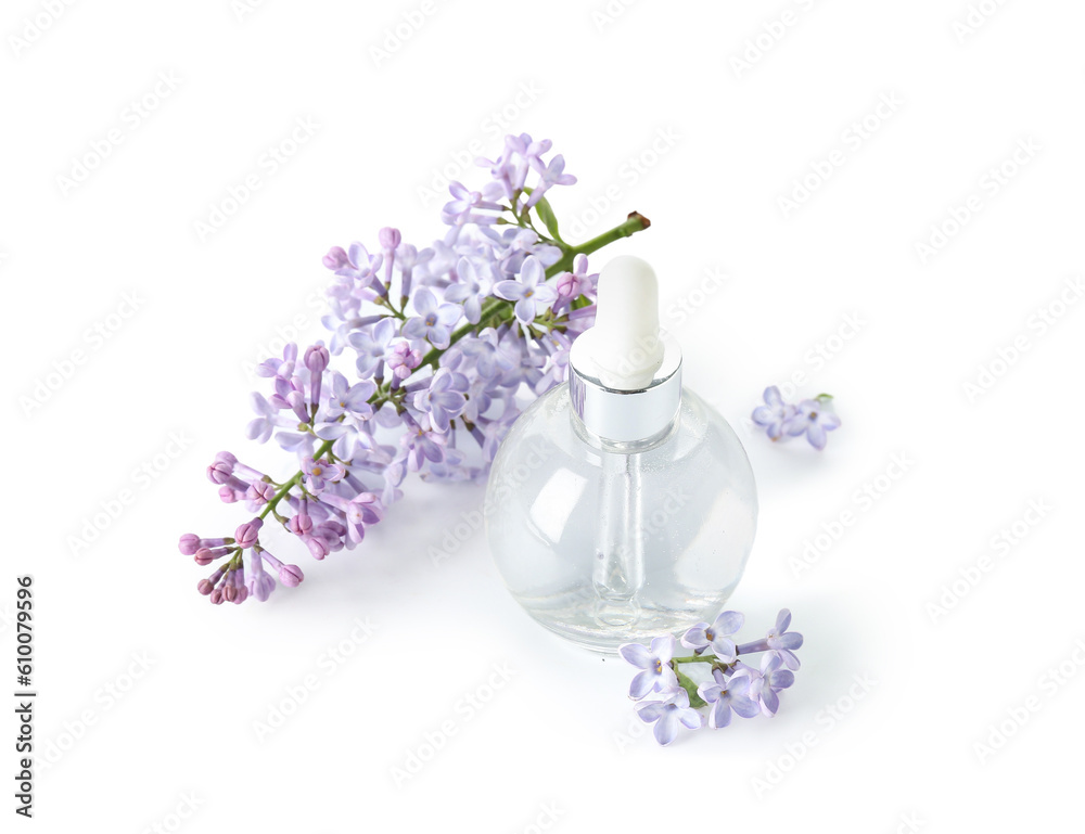 Bottle of cosmetic oil with beautiful lilac flowers on white background