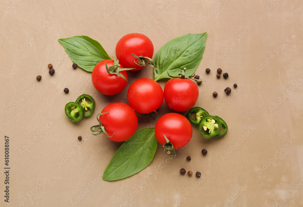 Composition with ripe cherry tomatoes, jalapeno and spices on color background