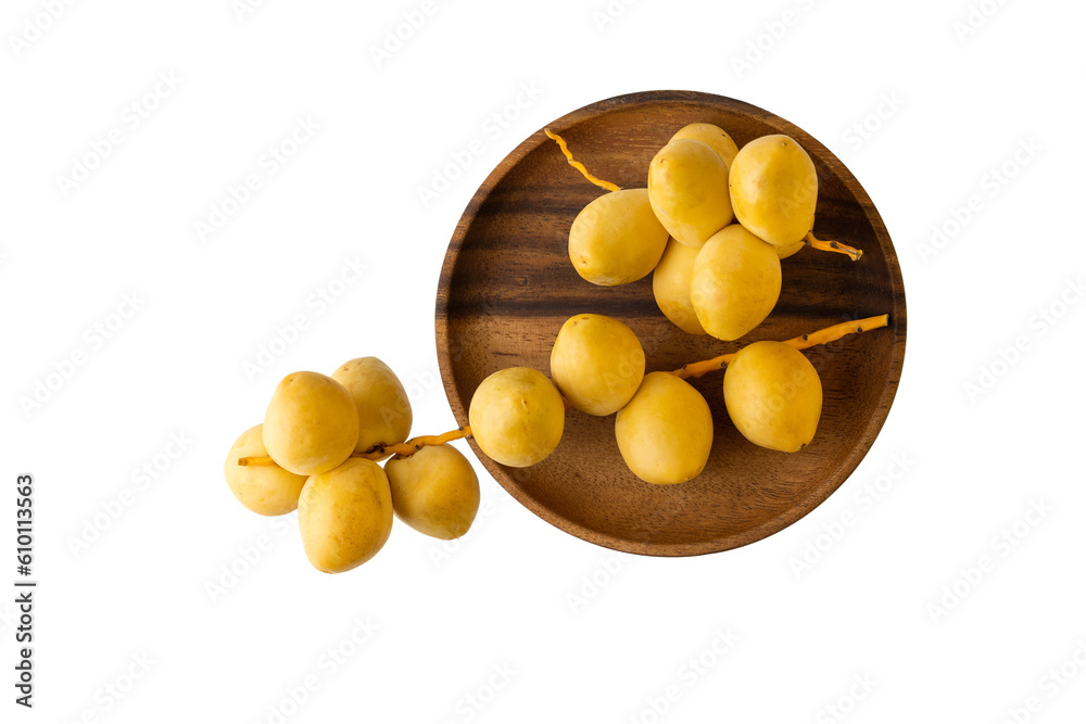 Ripe yellow dates bunches on wooden plate isolated on white