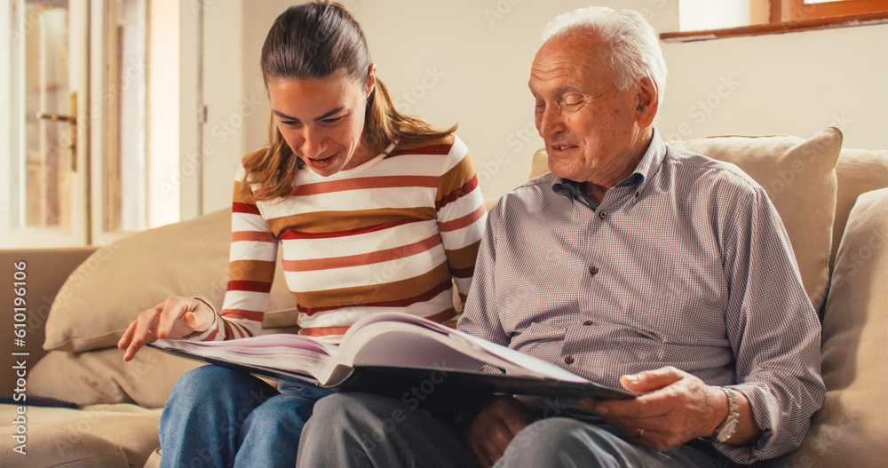 Portrait of a Nostalgic Woman Bringing the Family Photo Album to her Senior Father so They Can Watch