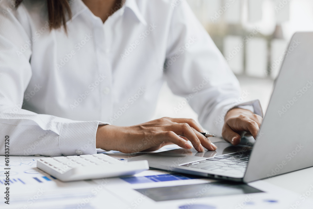 Businesswoman working with laptop and analyzing financial and accounting documents. Business woman w