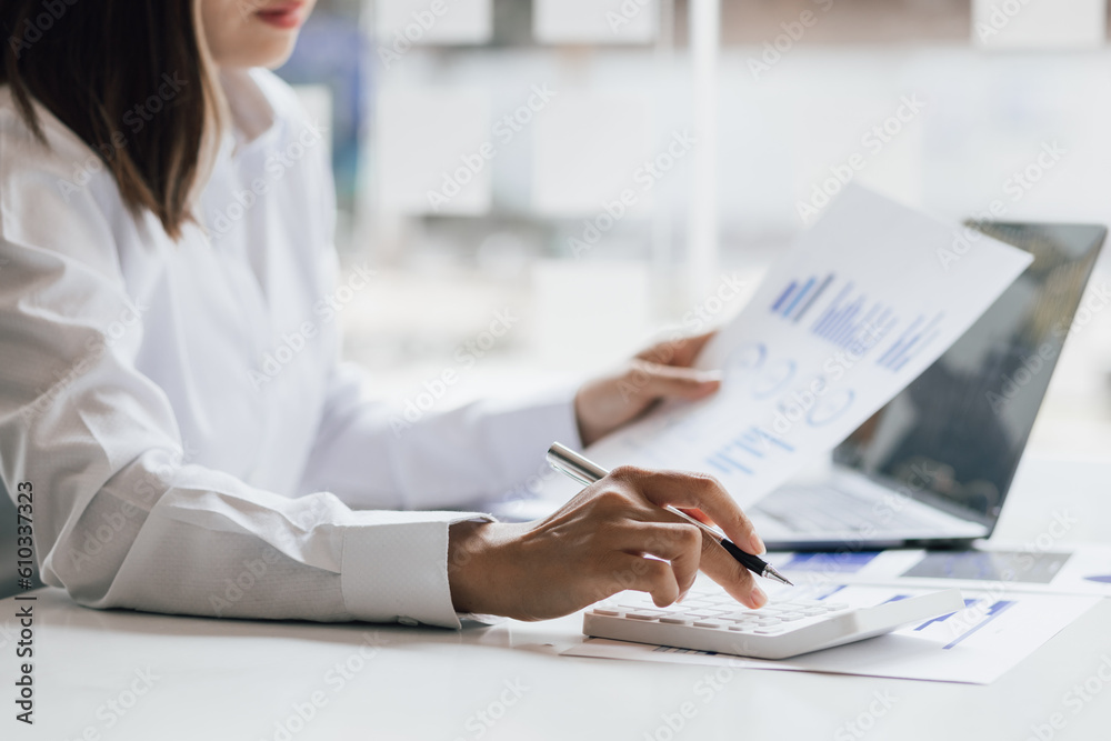 Businesswoman working with laptop and analyzing financial and accounting documents. Business woman w