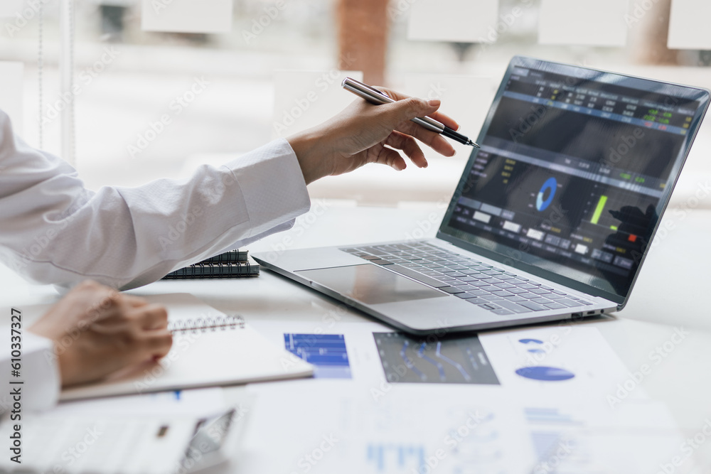 Businesswoman working with laptop and analyzing financial and accounting documents. Business woman w