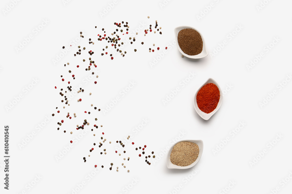 Frame made of bowls with spices and peppercorns on light background