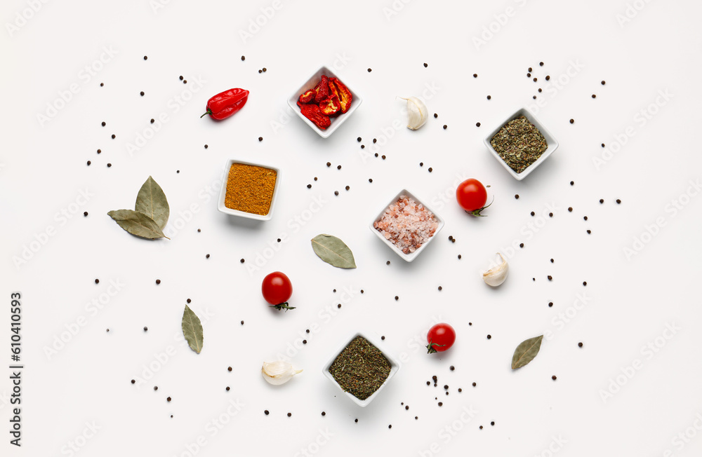 Composition with bowls of fresh spices and vegetables on light background