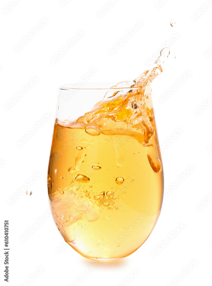 Glass of tasty apple cider with splashes and ice cube isolated on white background