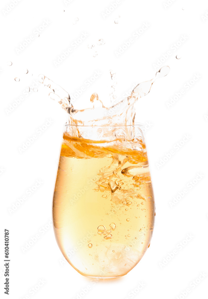 Glass of tasty apple cider with splashes and ice cube isolated on white background