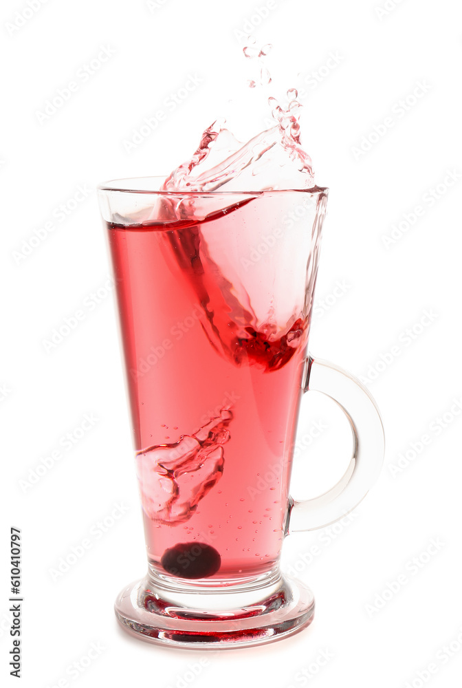 Glass of tasty blueberry cider with splashes, ice cube and berries isolated on white background