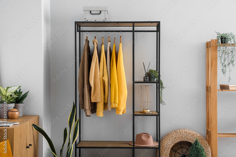 Interior of living room with shelving unit and clothes