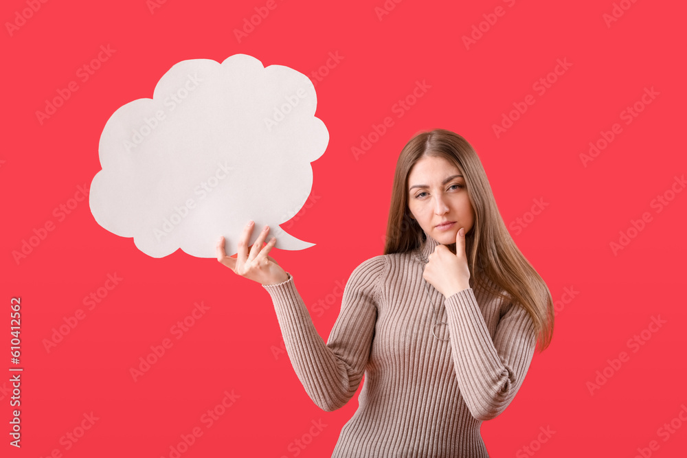 Thoughtful young woman with blank speech bubble on red background