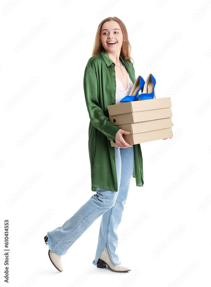 Young woman with shoe boxes on white background