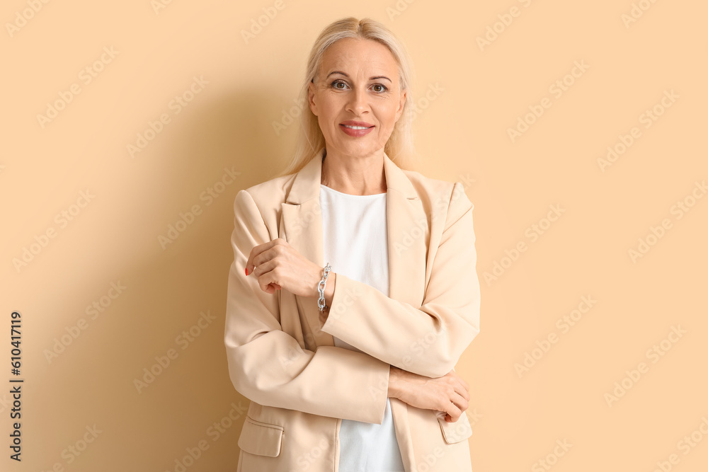 Mature blonde woman on beige background