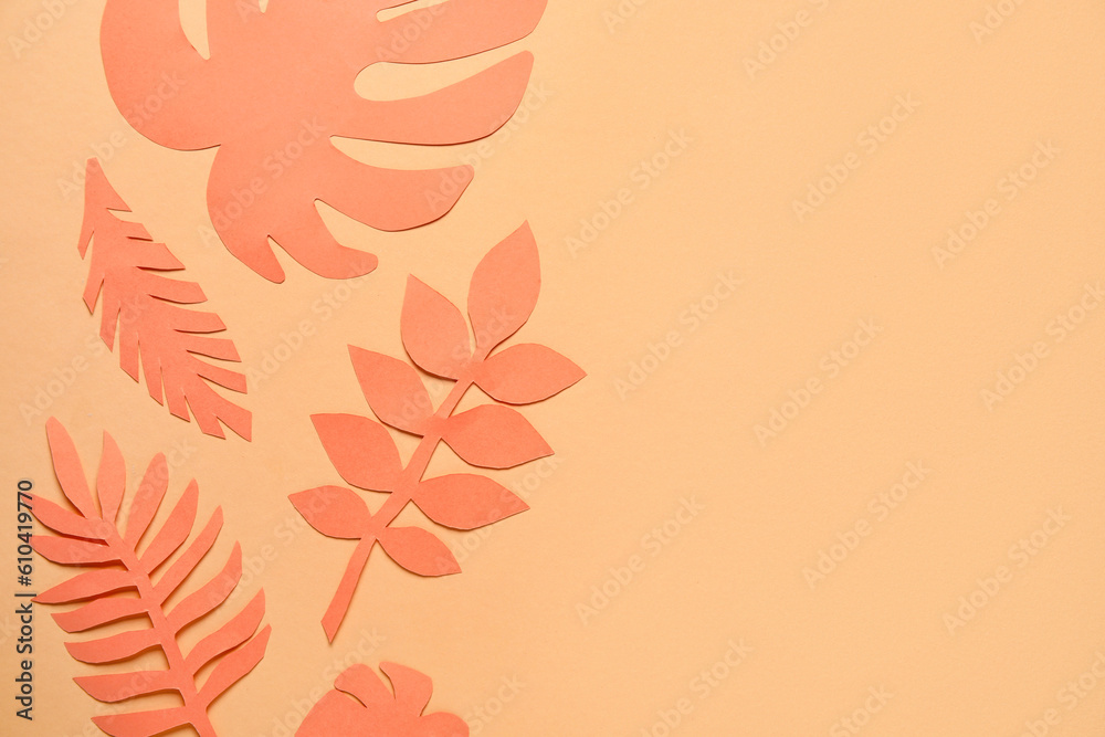 Different tropical leaves on pale orange background