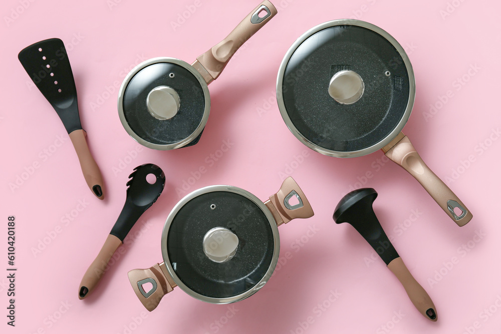 Set of kitchen utensils on pink background