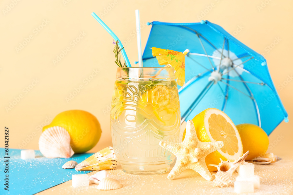 Mason jar with fresh lemonade and summer decor on beige background