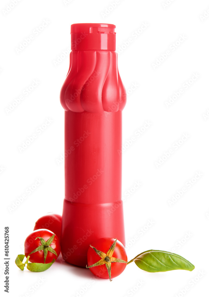 Bottle of ketchup and tomatoes on white background