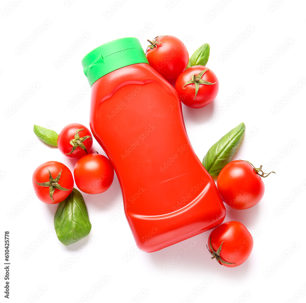 Bottle of ketchup and tomatoes on white background