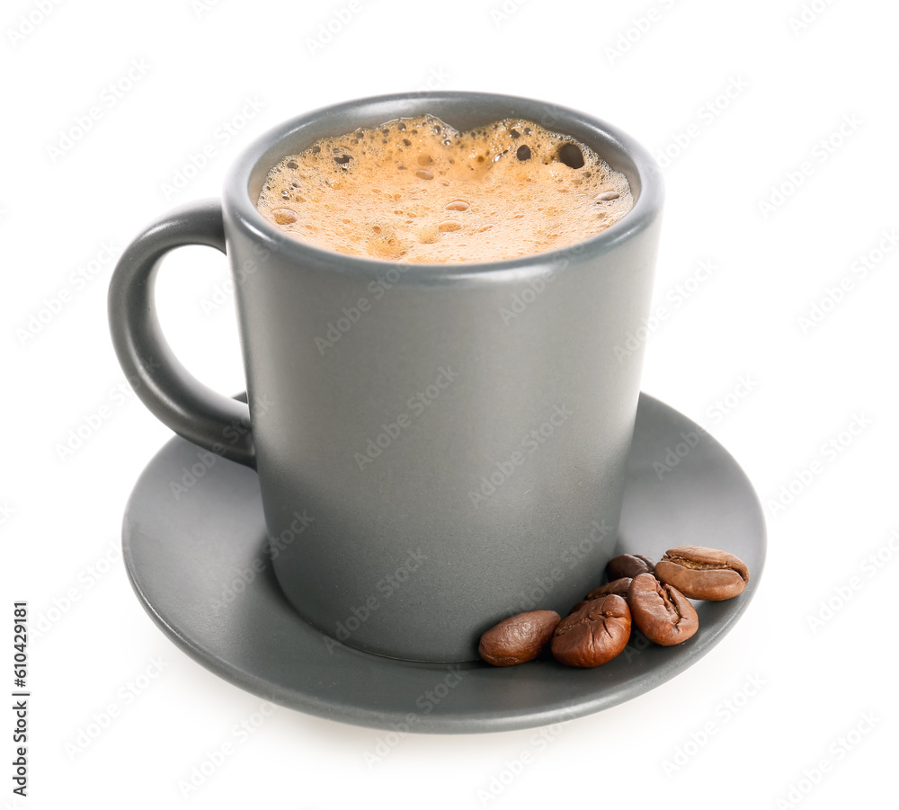 Cup of delicious espresso, coffee beans and saucer on white background