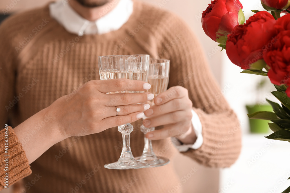 Happy engaged couple drinking wine in kitchen, closeup