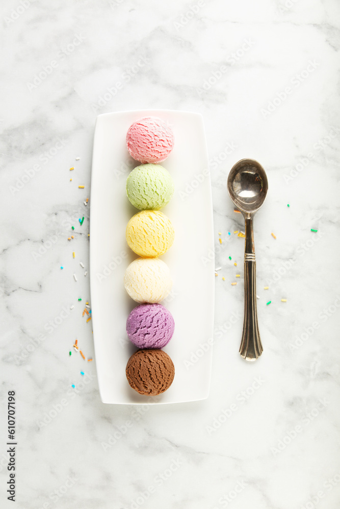 Set of various ice cream scoops on white marble background, top view