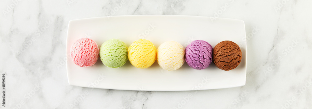 Set of various ice cream scoops on white marble background, top view