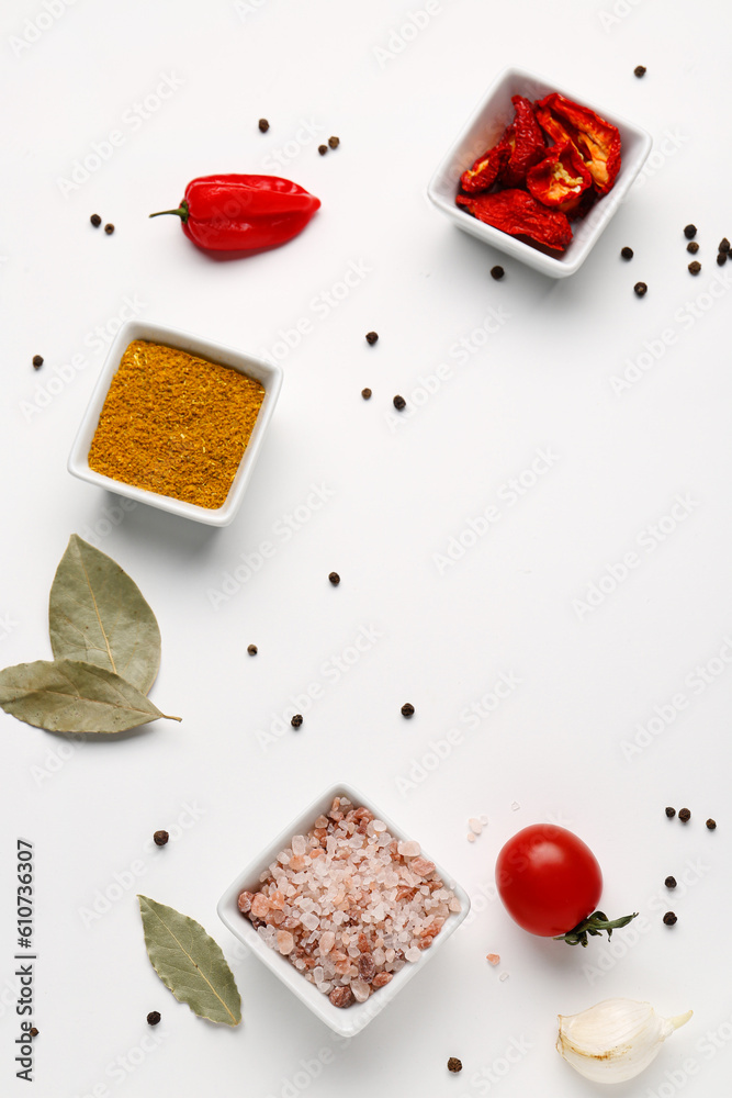 Composition with fresh aromatic spices and vegetables on light background