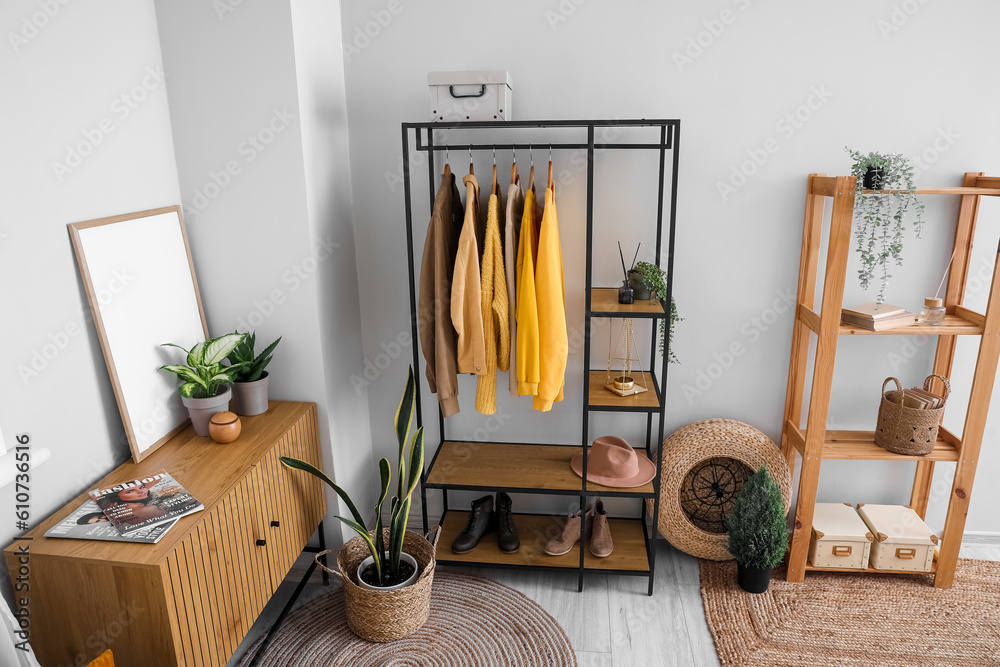 Interior of living room with shelving unit and clothes