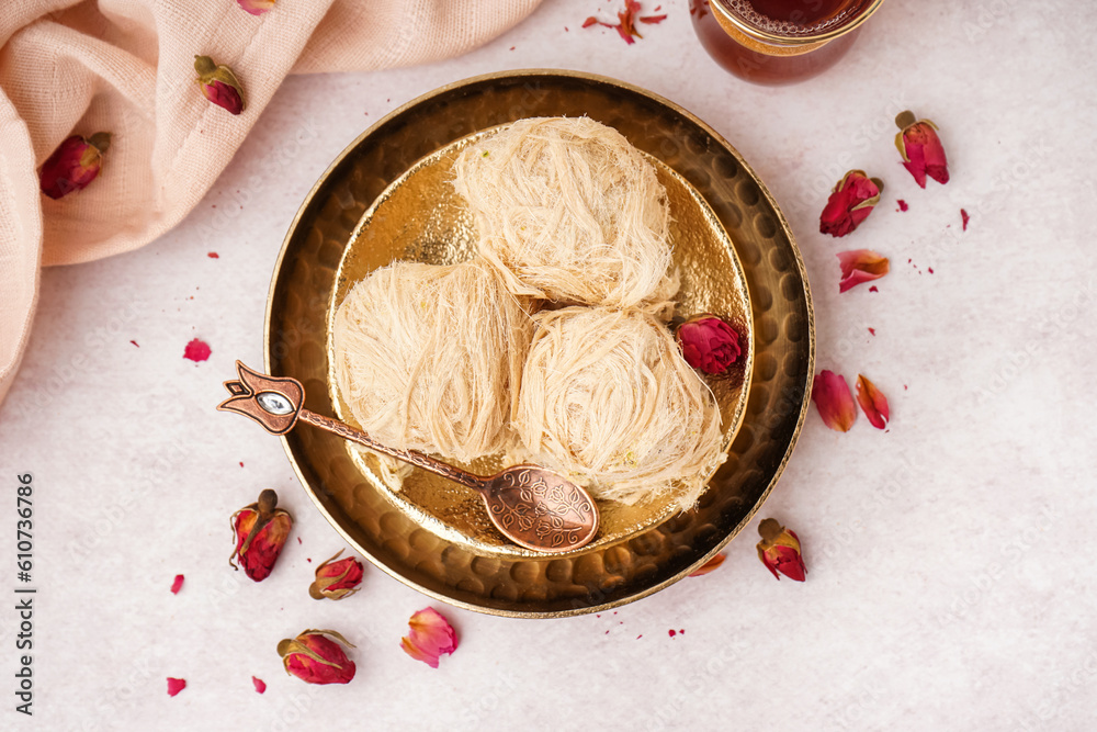 Plates with tasty Turkish Pismaniye on light background